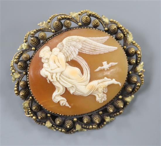 A yellow metal mounted ova shell cameo brooch, carved with Nyx, Goddess of the Night with her children, 46mm.